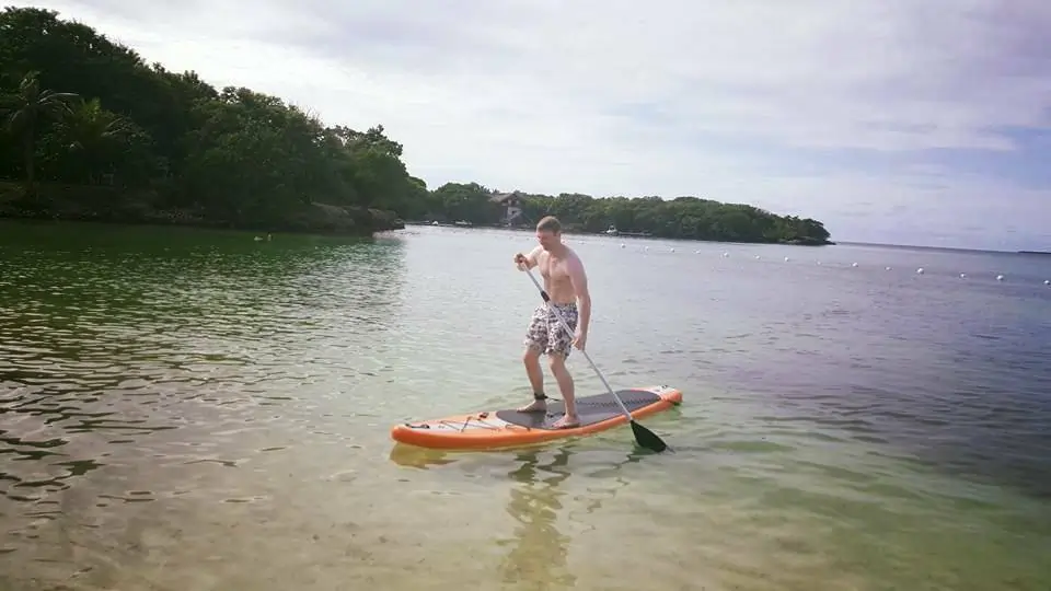 Personal trainer Scott Laidler paddle-boarding in Colombia