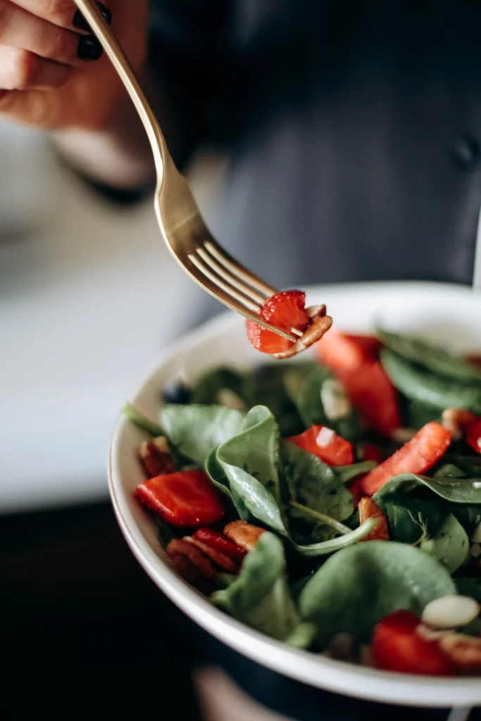 Healthy bowl of salad and strawberries