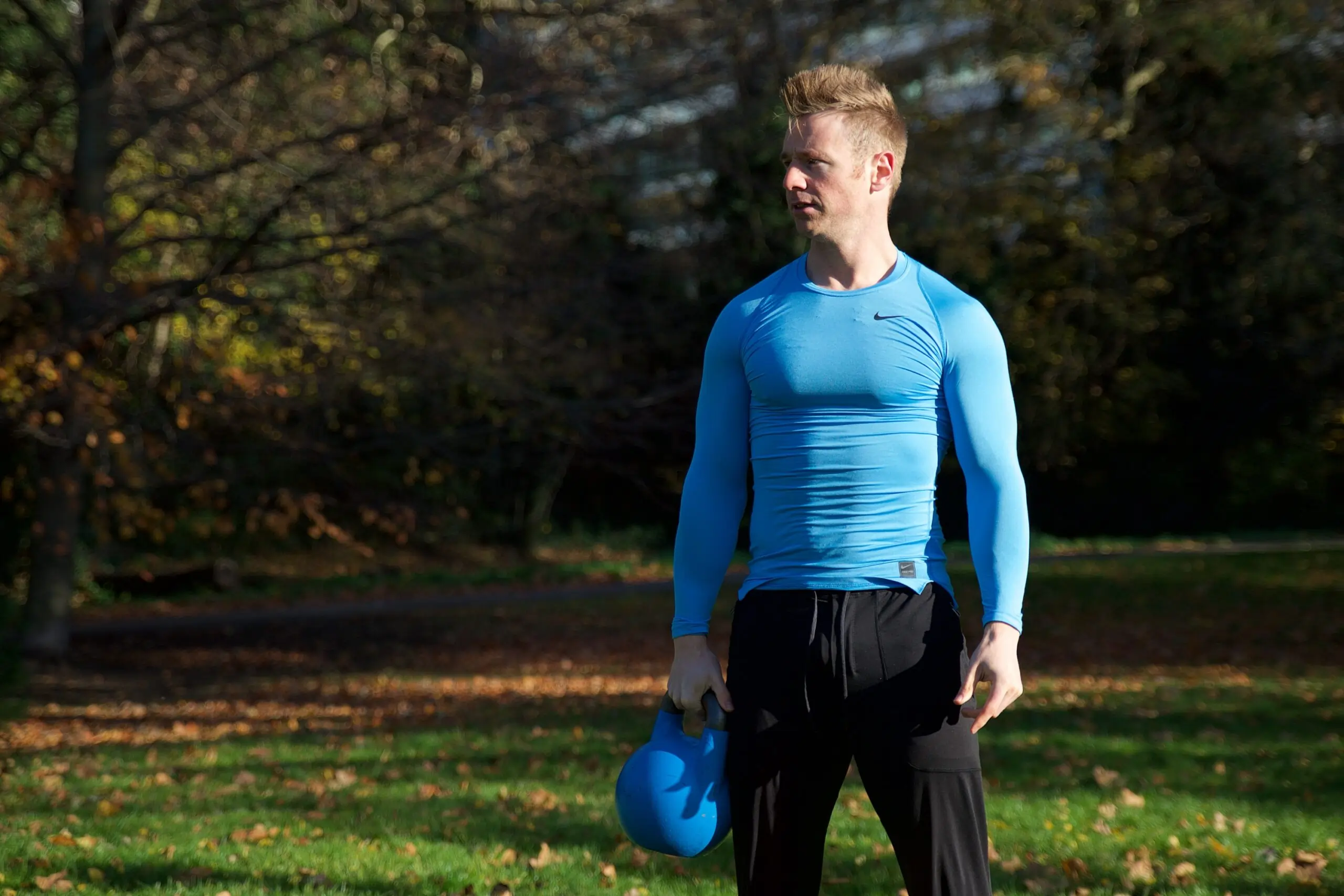 Personal trainer Scott Laidler in Hyde Park London with blue kettlebell