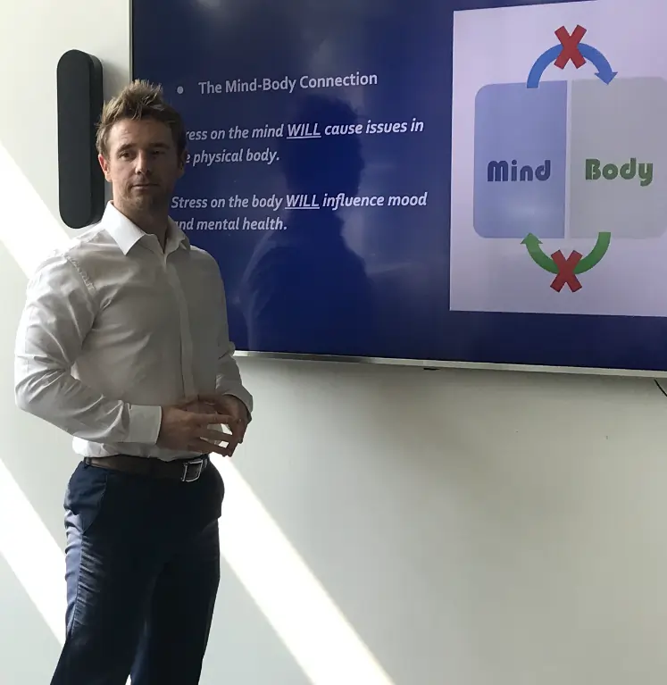 Personal trainer Scott Laidler giving corporate wellness talk in boardroom