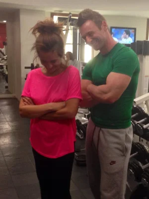 Actress Kierston Wareing laughing with personal trainer Scott Laidler in London gym