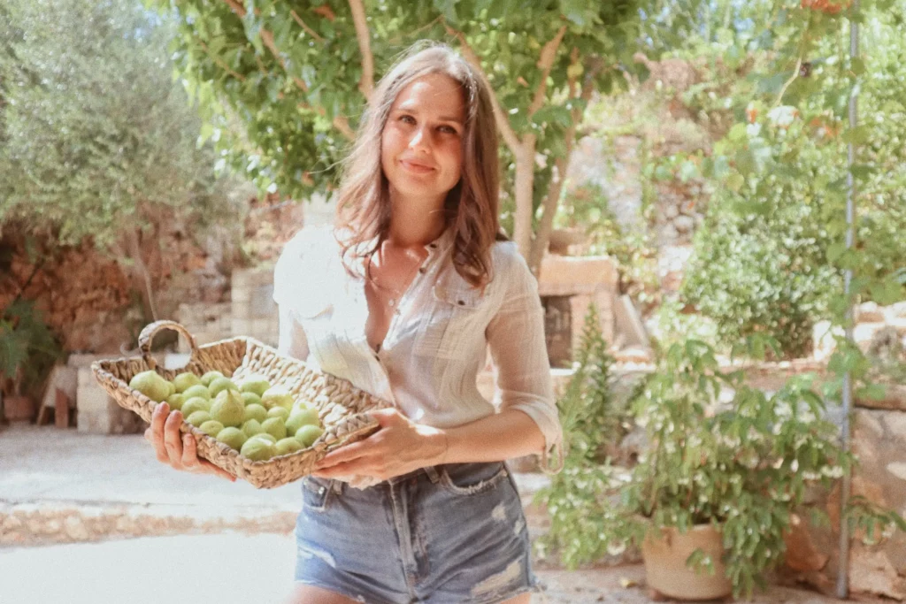 Nutritionist Dr Katie Turianytsia enjoying fruit in a garden in Crete