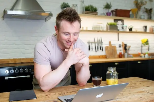 Online personal trainer Scott Laidler speaking with Clients on laptop computer