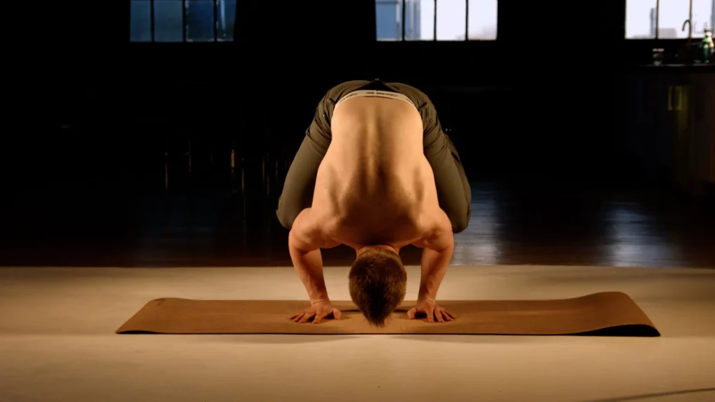 Fitness trainer Scott Laidler demonstrates crow yoga pose