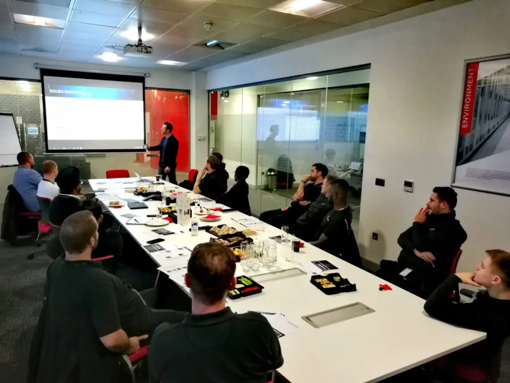 Scott Laidler delivering a corporate wellness presentation to a group of engineers in a board room