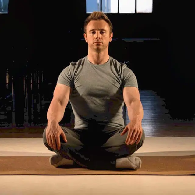 Personal trainer Scott Laidler in lotus position meditating on a yoga mat